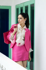 White ruffled top with pink jacket and pink slit shorts